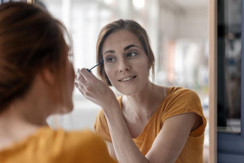 Woman applying eye lash growth serum 