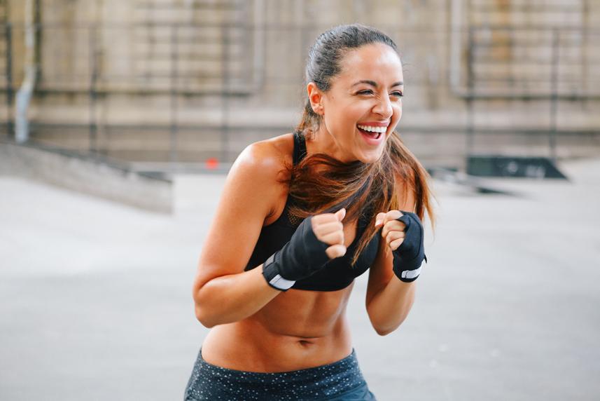 Smiling woman in boxing pose
