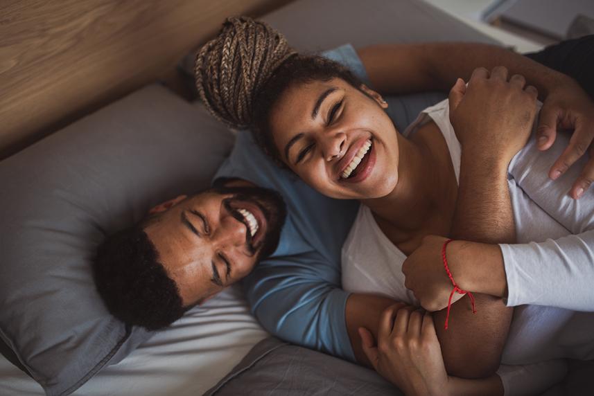 Couple hugging on bed and rethinking birth control
