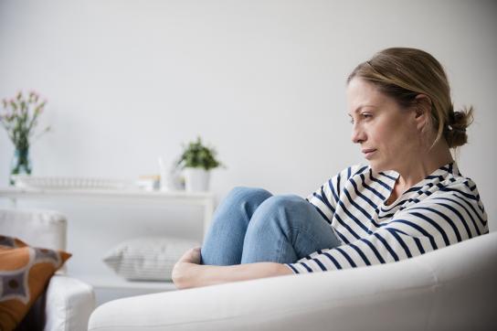 Woman grieving on the couch after a divorce