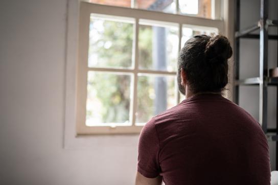 Man with panic attack staring out the window